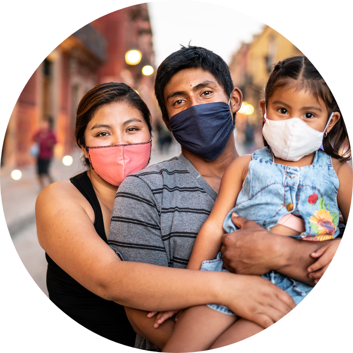 Latino family with one girl, all wearing masks