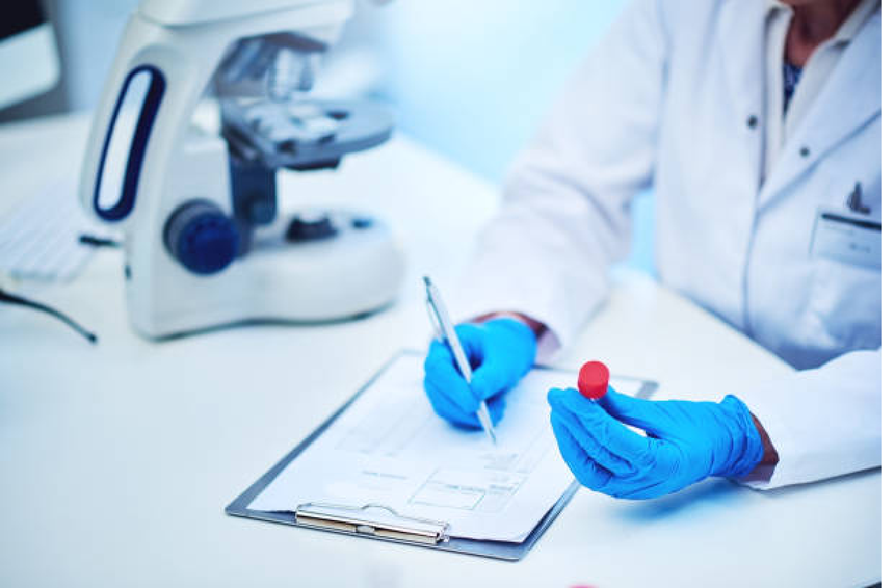 Scientist in lab holding vial